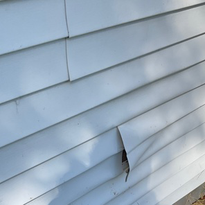 Damaged exterior siding on home in Cuyahoga County.