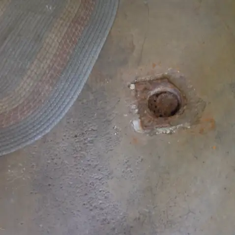 Hidden defective drain line found under rug in Cuyahoga County.