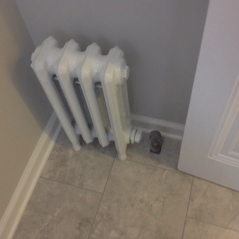 Disconnected heating radiator unit in a freshly remodeled home in Cuyahoga County.