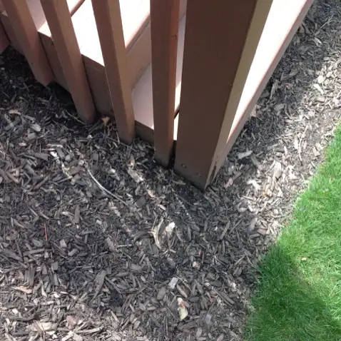 Improper earth to wood contact causing rot risk in Cuyahoga County